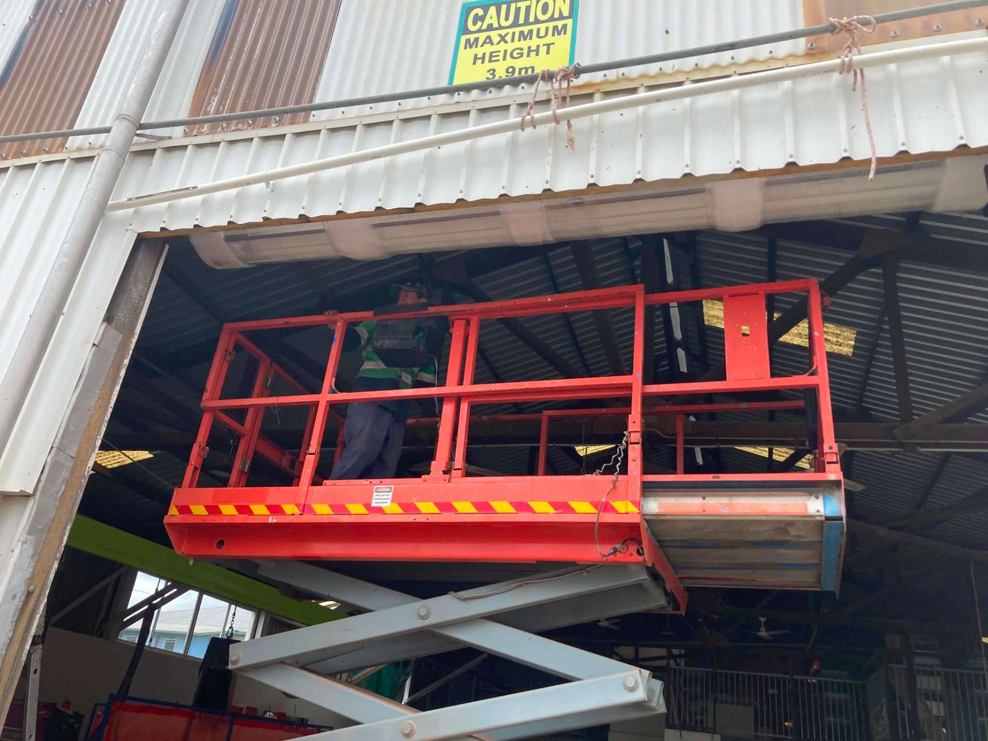 Servicing a roller shutter on a height-restricted commercial structure