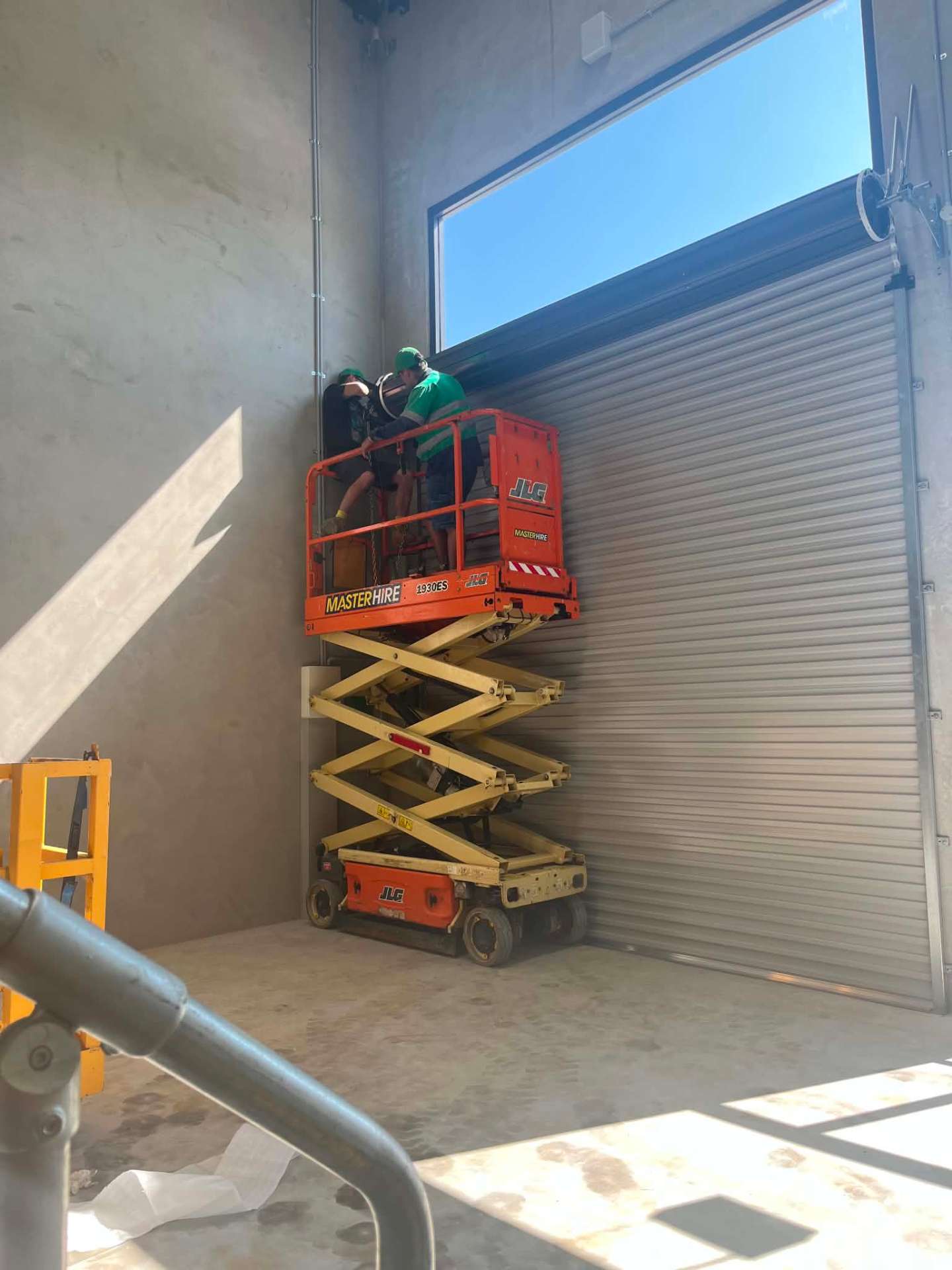 Installing an industrial roller door in a commercial warehouse